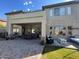Large covered patio with dining area, comfortable seating, and ceiling fan at 3852 E Expedition Way, Phoenix, AZ 85050