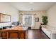 Home office with large desk, comfortable sofa, and hardwood floors at 3852 E Expedition Way, Phoenix, AZ 85050
