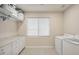 Bright laundry room with washer, dryer, and ample storage at 3852 E Expedition Way, Phoenix, AZ 85050