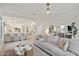 Open living room with kitchen views, neutral palette, and modern furniture at 3852 E Expedition Way, Phoenix, AZ 85050