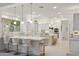 Bright kitchen with white cabinets, marble countertops, and stainless steel appliances at 3852 E Expedition Way, Phoenix, AZ 85050
