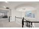 Elegant upstairs hallway with chandelier and curved staircase at 3852 E Expedition Way, Phoenix, AZ 85050
