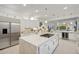 Modern kitchen with large island, white cabinets, and stainless steel appliances at 3852 E Expedition Way, Phoenix, AZ 85050