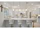 Gourmet kitchen with white cabinets, marble countertops and breakfast bar at 3852 E Expedition Way, Phoenix, AZ 85050