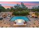 Expansive backyard oasis with a sparkling pool, spa, and fire features at 3852 E Expedition Way, Phoenix, AZ 85050
