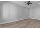 Bright bedroom with ceiling fan, wood-look floors, and double door closet at 26761 S 181St Pl, Queen Creek, AZ 85142