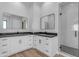 Elegant bathroom with dual vanities, walk-in shower, and dark countertop at 26761 S 181St Pl, Queen Creek, AZ 85142