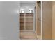 Large walk-in closet with built-in shelves and hanging rod at 26761 S 181St Pl, Queen Creek, AZ 85142