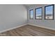 Bright bedroom with laminate wood floors and large windows at 26761 S 181St Pl, Queen Creek, AZ 85142