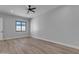 Spacious bedroom with wood-look floors and a window with natural light at 26761 S 181St Pl, Queen Creek, AZ 85142