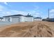 New construction home showcasing a three-car garage, clean lines, and desert landscaping at 26761 S 181St Pl, Queen Creek, AZ 85142