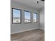 Bright bedroom with wood floors and three large windows at 26761 S 181St Pl, Queen Creek, AZ 85142