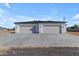 New home's exterior features a three-car garage and modern design at 26761 S 181St Pl, Queen Creek, AZ 85142