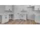 White cabinets, wood flooring, and a built-in desk area at 26761 S 181St Pl, Queen Creek, AZ 85142