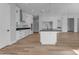 Modern kitchen with white cabinets, island, and dark countertop at 26761 S 181St Pl, Queen Creek, AZ 85142