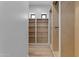 Large walk-in closet with built-in shelves and hanging rod at 26615 S 181St Pl, Queen Creek, AZ 85142