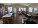 Open living room and kitchen with vaulted ceilings, wood-look floors, and ample natural light at 650 N Hawes Rd # 4507, Mesa, AZ 85207