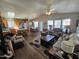 Open living room and kitchen with vaulted ceilings, wood-look floors, and ample natural light at 650 N Hawes Rd # 4507, Mesa, AZ 85207