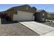 Single-story home with attached garage and desert landscaping at 10537 W Florence Ave, Tolleson, AZ 85353