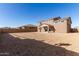 A two-story house with a dirt backyard, viewed from behind at 21665 E Roundup Way, Queen Creek, AZ 85142