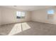 Large, carpeted bedroom with windows showcasing a neighborhood view at 21665 E Roundup Way, Queen Creek, AZ 85142