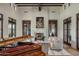 Elegant living room featuring a fireplace and large windows at 10673 E Wingspan Way, Scottsdale, AZ 85255