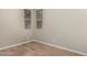 Bright bedroom featuring wood-look flooring and large windows at 21711 E Roundup N Way, Queen Creek, AZ 85142