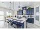 Modern kitchen with a large island and dark blue cabinetry at 19819 W Thomas Rd, Buckeye, AZ 85396