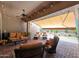 Relaxing covered patio furnished with wicker seating and views of the backyard at 12349 W Tyler Trl, Peoria, AZ 85383