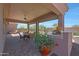 Outdoor kitchen and dining area on a covered patio at 12349 W Tyler Trl, Peoria, AZ 85383