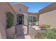 Inviting front entrance with a courtyard, wrought iron gate, and seating area at 12349 W Tyler Trl, Peoria, AZ 85383