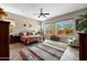 Spacious bedroom with large windows, ceiling fan, and view of the backyard at 12349 W Tyler Trl, Peoria, AZ 85383