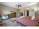 Main bedroom with large bed, access to bathroom, and plenty of natural light at 12349 W Tyler Trl, Peoria, AZ 85383