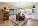 Charming breakfast nook with a round table, wood chairs, and view to the backyard at 12349 W Tyler Trl, Peoria, AZ 85383
