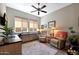 Bright home office with built-in desk, ceiling fan, and comfortable seating at 12349 W Tyler Trl, Peoria, AZ 85383