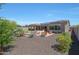 Large backyard with putting green, fire pit, and solar panels on the home at 12349 W Tyler Trl, Peoria, AZ 85383