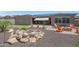 Backyard oasis with a fire pit, putting green, and a rock waterfall feature at 12349 W Tyler Trl, Peoria, AZ 85383