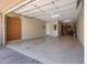 Two-car garage with extra storage cabinets and epoxy flooring at 12349 W Tyler Trl, Peoria, AZ 85383