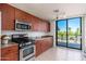 Kitchen with patio access, stainless steel appliances, and wood cabinets at 2302 N Central N Ave # 302, Phoenix, AZ 85004