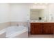 Main bathroom with a large corner tub, double vanity, and mirror at 2302 N Central N Ave # 302, Phoenix, AZ 85004