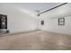 Garage with carpeted floor and storage at 2127 E Huntington Dr, Phoenix, AZ 85040