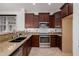 Modern kitchen with granite counters, stainless steel appliances, and dark wood cabinets at 2127 E Huntington Dr, Phoenix, AZ 85040