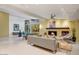 Spacious living area with a fireplace, comfortable seating, and large windows at 8517 N 48Th Pl, Paradise Valley, AZ 85253