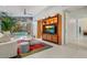 Bright living room featuring a large TV, comfortable seating, and pool view at 8517 N 48Th Pl, Paradise Valley, AZ 85253