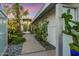 Inviting walkway through a serene courtyard with lush greenery and stone accents at 8517 N 48Th Pl, Paradise Valley, AZ 85253