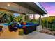Relaxing patio with sectional sofa and colorful pillows overlooking the pool and desert landscape at 8517 N 48Th Pl, Paradise Valley, AZ 85253