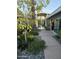 Stone path meanders through a beautifully landscaped courtyard with native plants at 8517 N 48Th Pl, Paradise Valley, AZ 85253