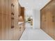 Long hallway with wood cabinets and view to living room at 8517 N 48Th Pl, Paradise Valley, AZ 85253