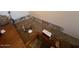 Image shows a living room with damaged carpet and exposed wall at 46157 W Holly Dr, Maricopa, AZ 85139
