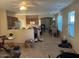 Spacious living room with tile flooring and access to kitchen at 46157 W Holly Dr, Maricopa, AZ 85139